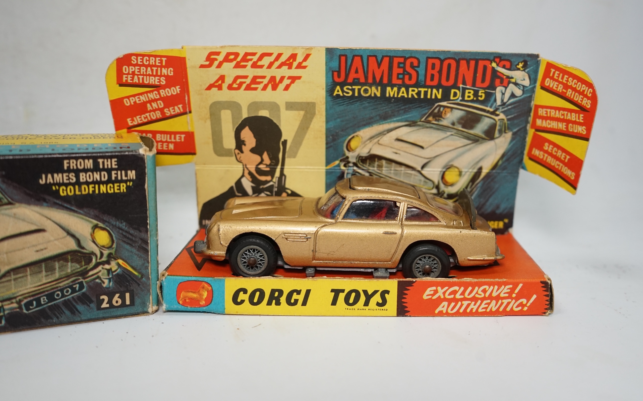 A boxed Corgi Toys James Bond 007 Aston Martin DB5 (261), a gold Aston Martin, with inner display stand, the envelope for the secret instructions (contents missing), the correct James Bond advertising leaflet and two pas